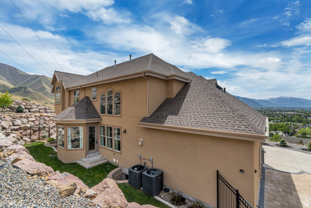 2543 East 700 South Springville, UT 84663 - Photo 12 of 73 View of side of property featuring a mountain view, a shingled roof, and stucco siding