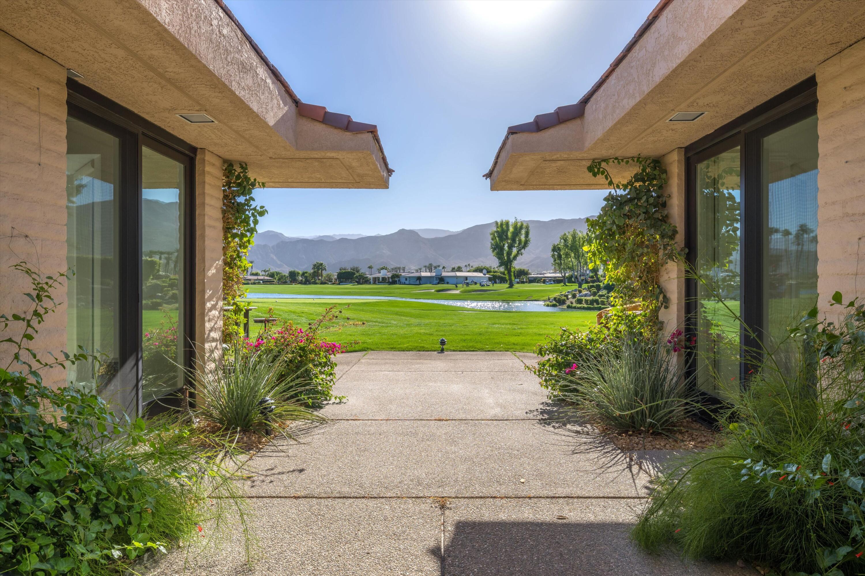 1 Mayfair Drive Rancho Mirage, CA 92270 - Photo 11 of 40 a view of a city with lawn chairs under an umbrella