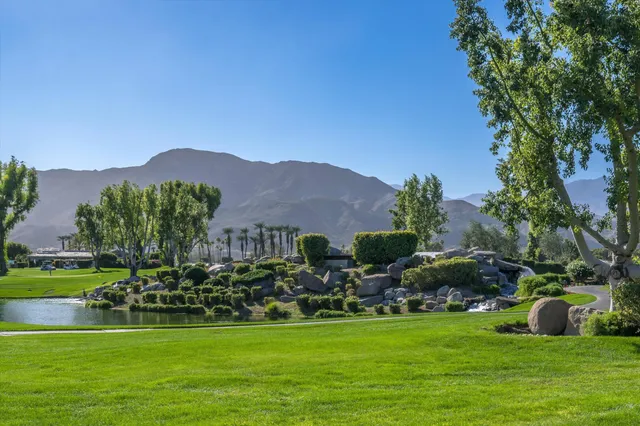 a living room with furniture rug and wooden floor