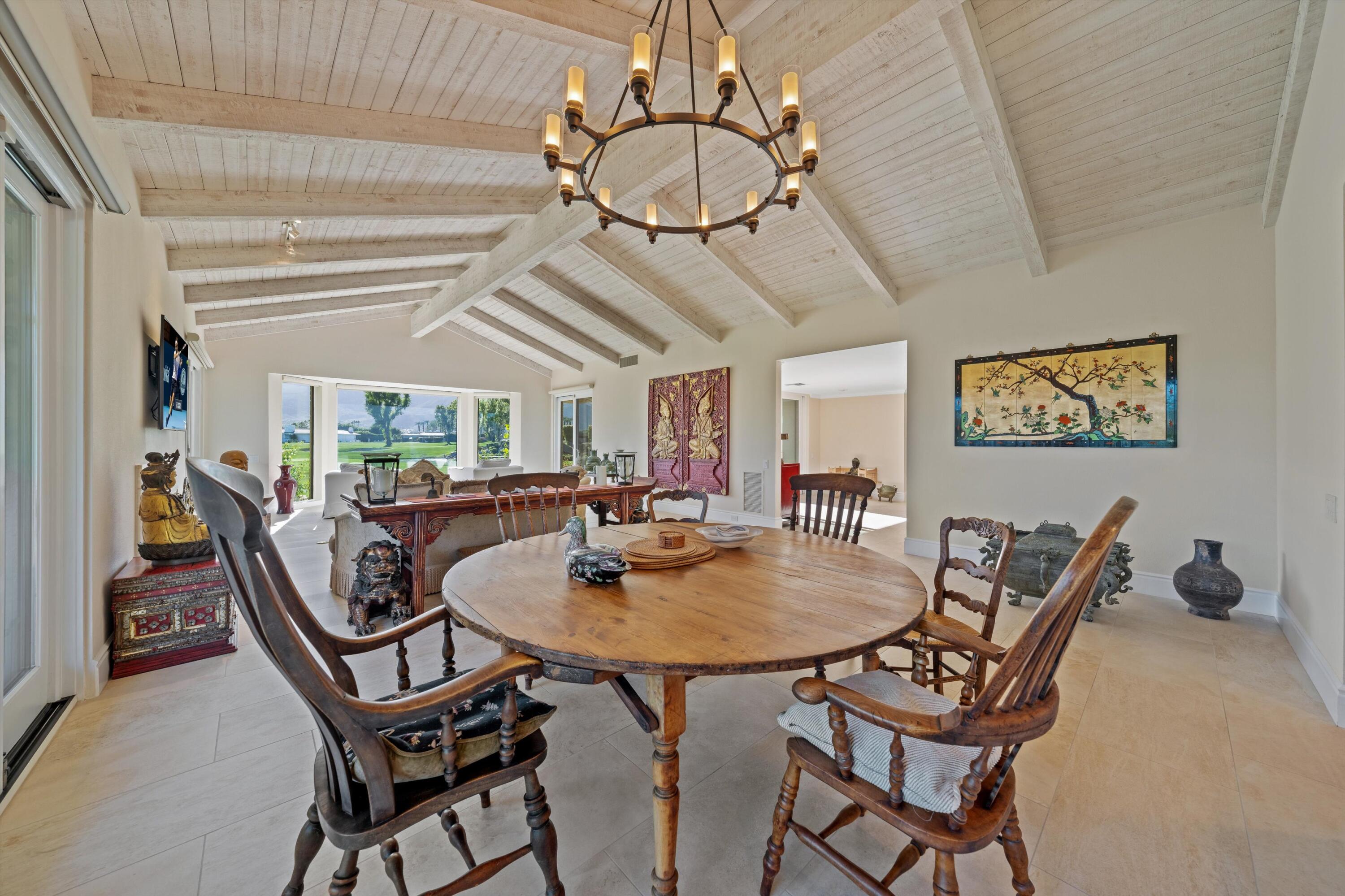 1 Mayfair Drive Rancho Mirage, CA 92270 - Photo 20 of 40 a dining room with furniture and a chandelier