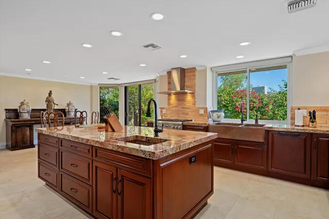 a kitchen with stainless steel appliances granite countertop a stove a sink and a refrigerator