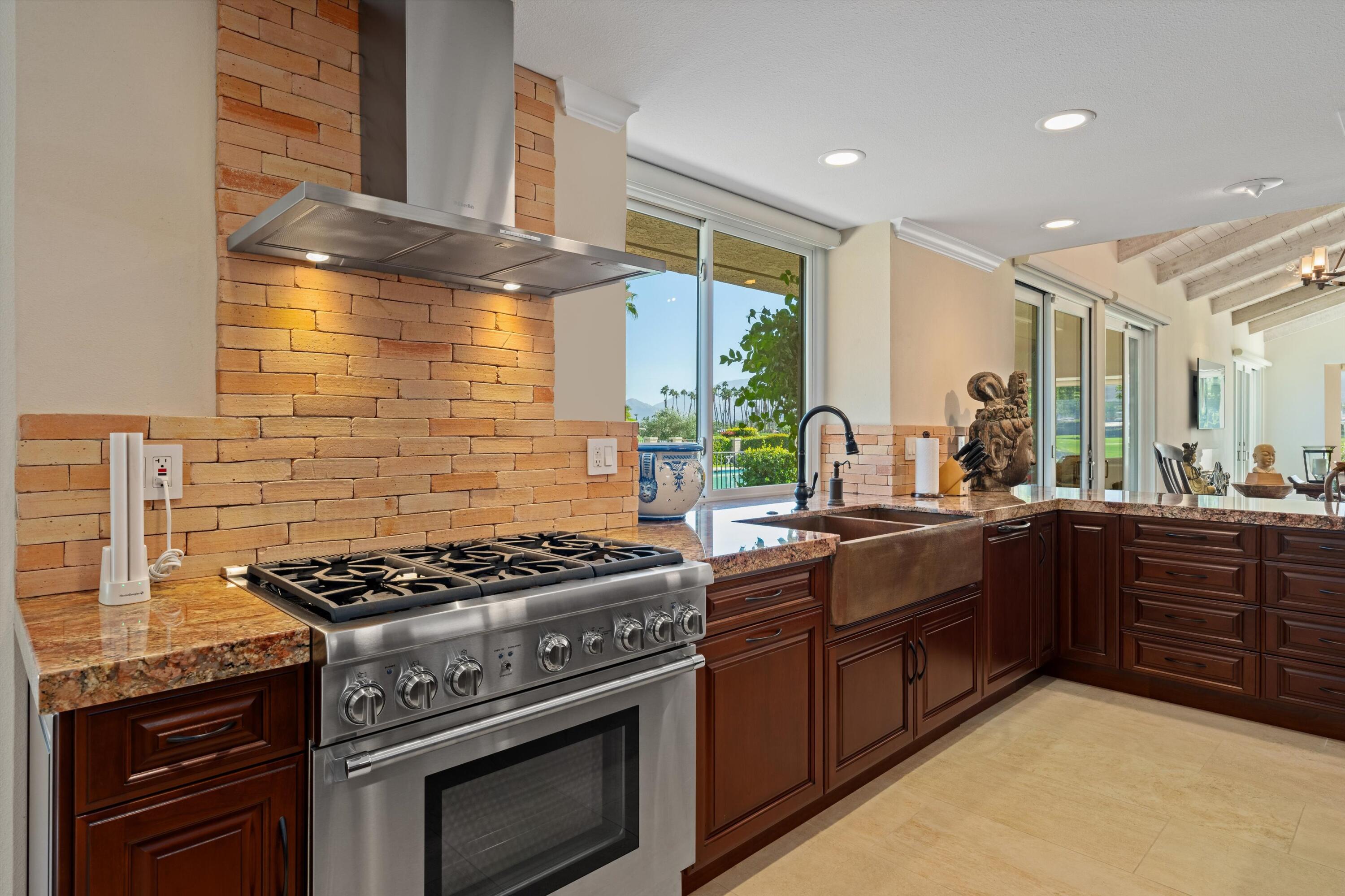 1 Mayfair Drive Rancho Mirage, CA 92270 - Photo 24 of 40 a kitchen with stainless steel appliances granite countertop a stove and a sink