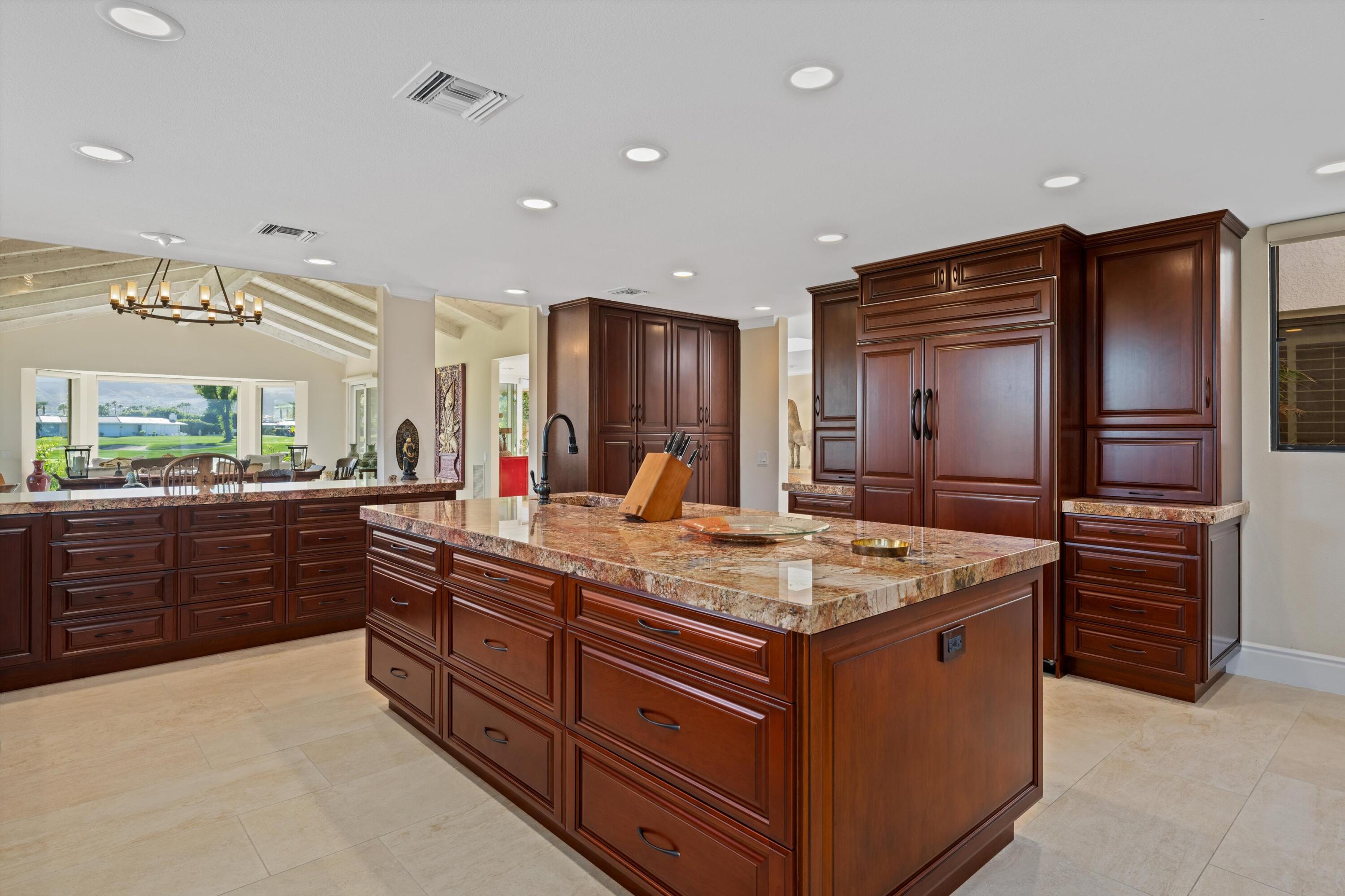 1 Mayfair Drive Rancho Mirage, CA 92270 - Photo 25 of 40 a kitchen with stainless steel appliances granite countertop a stove a sink and a refrigerator