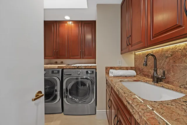 a spacious bathroom with a double vanity sink double mirror and bathtub