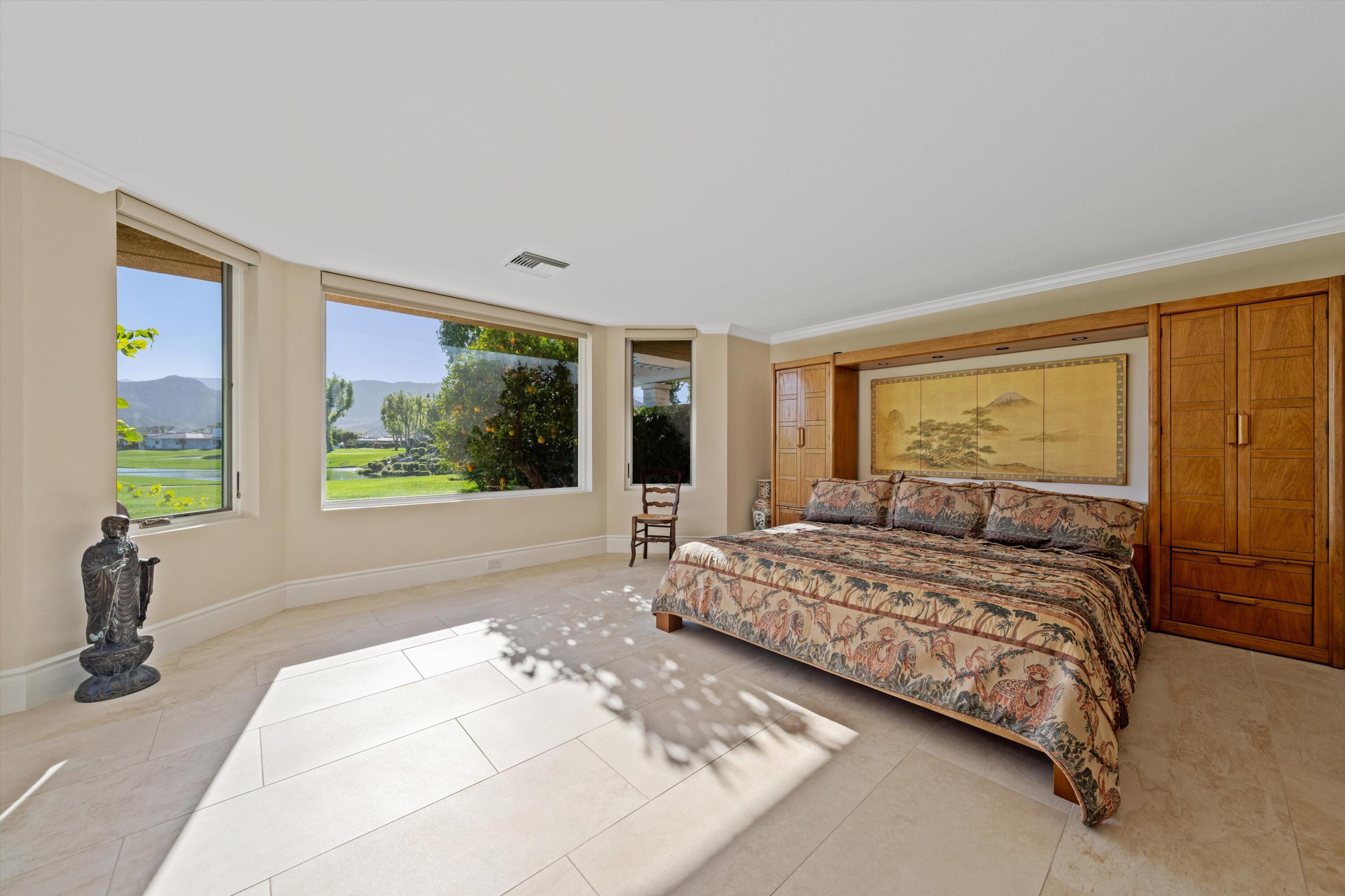 1 Mayfair Drive Rancho Mirage, CA 92270 - Photo 29 of 40 a bedroom with a large bed and a large window