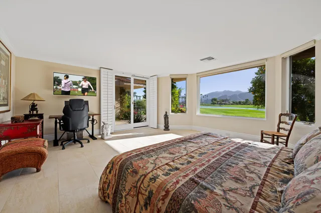 a bedroom with furniture and a window