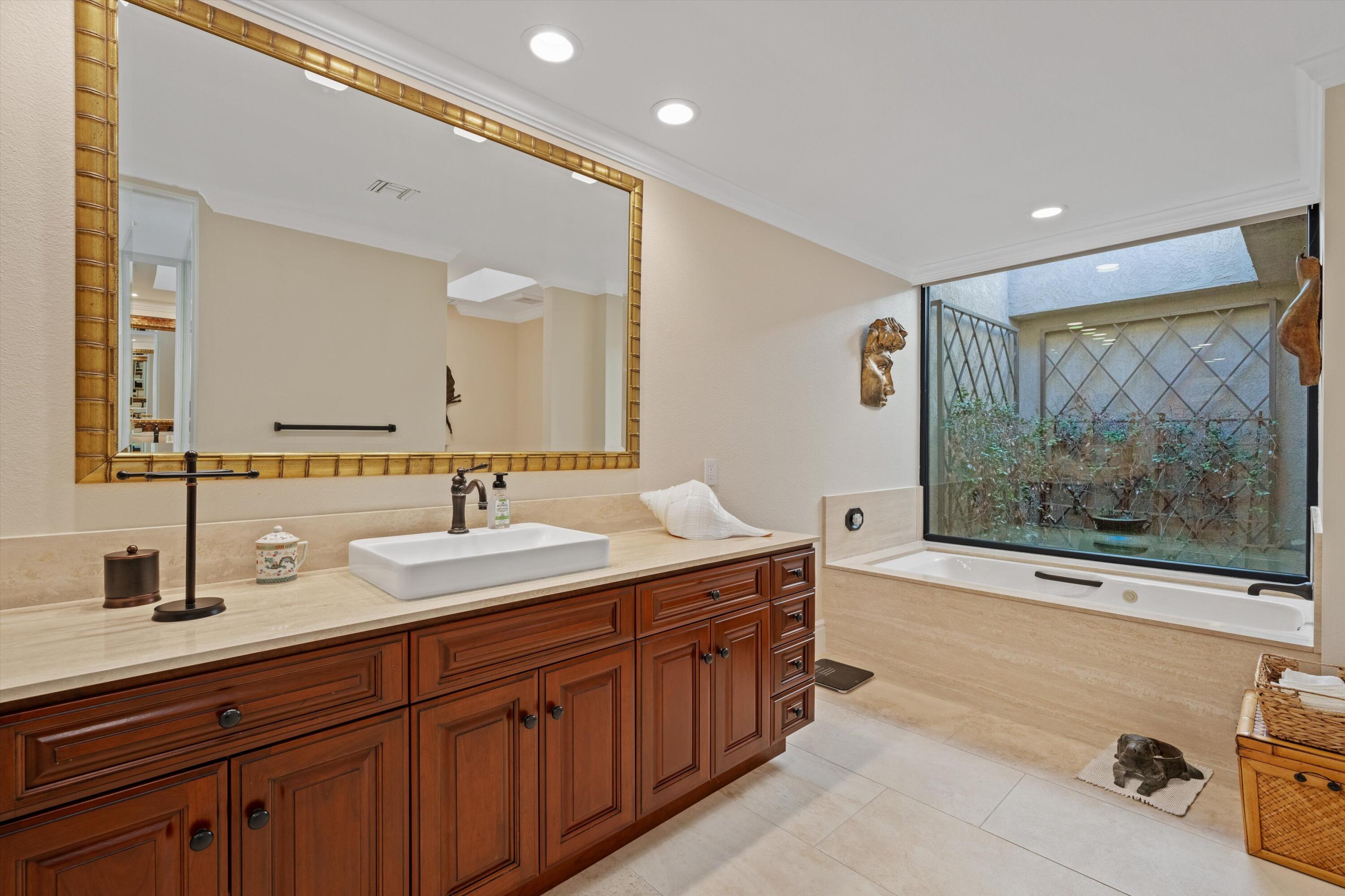 1 Mayfair Drive Rancho Mirage, CA 92270 - Photo 31 of 40 a spacious bathroom with a double vanity sink double mirror and bathtub
