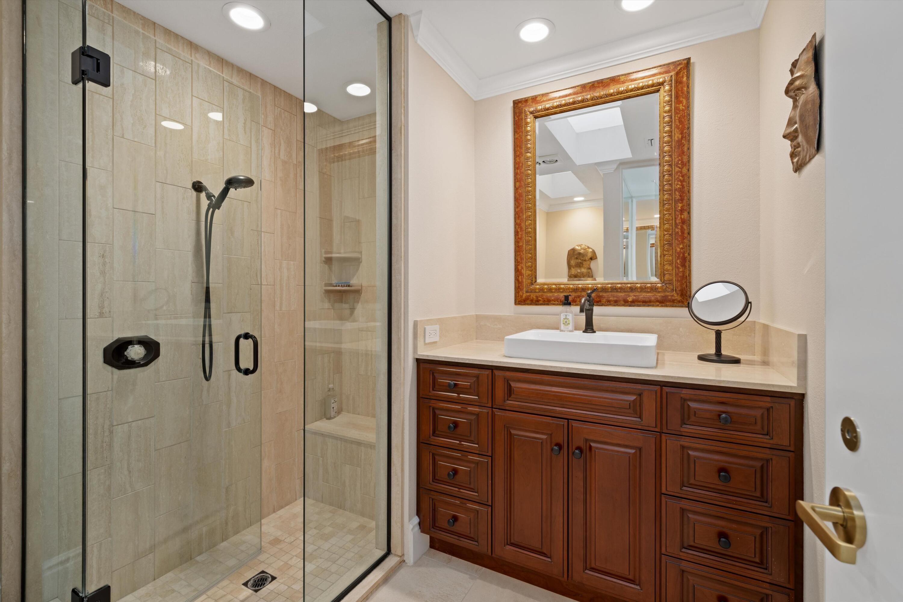 1 Mayfair Drive Rancho Mirage, CA 92270 - Photo 32 of 40 a bathroom with a shower sink vanity and mirror