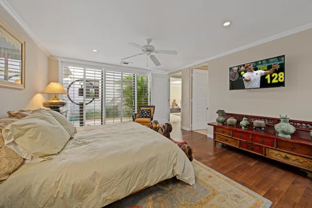 a dining room with furniture a chandelier and wooden floor