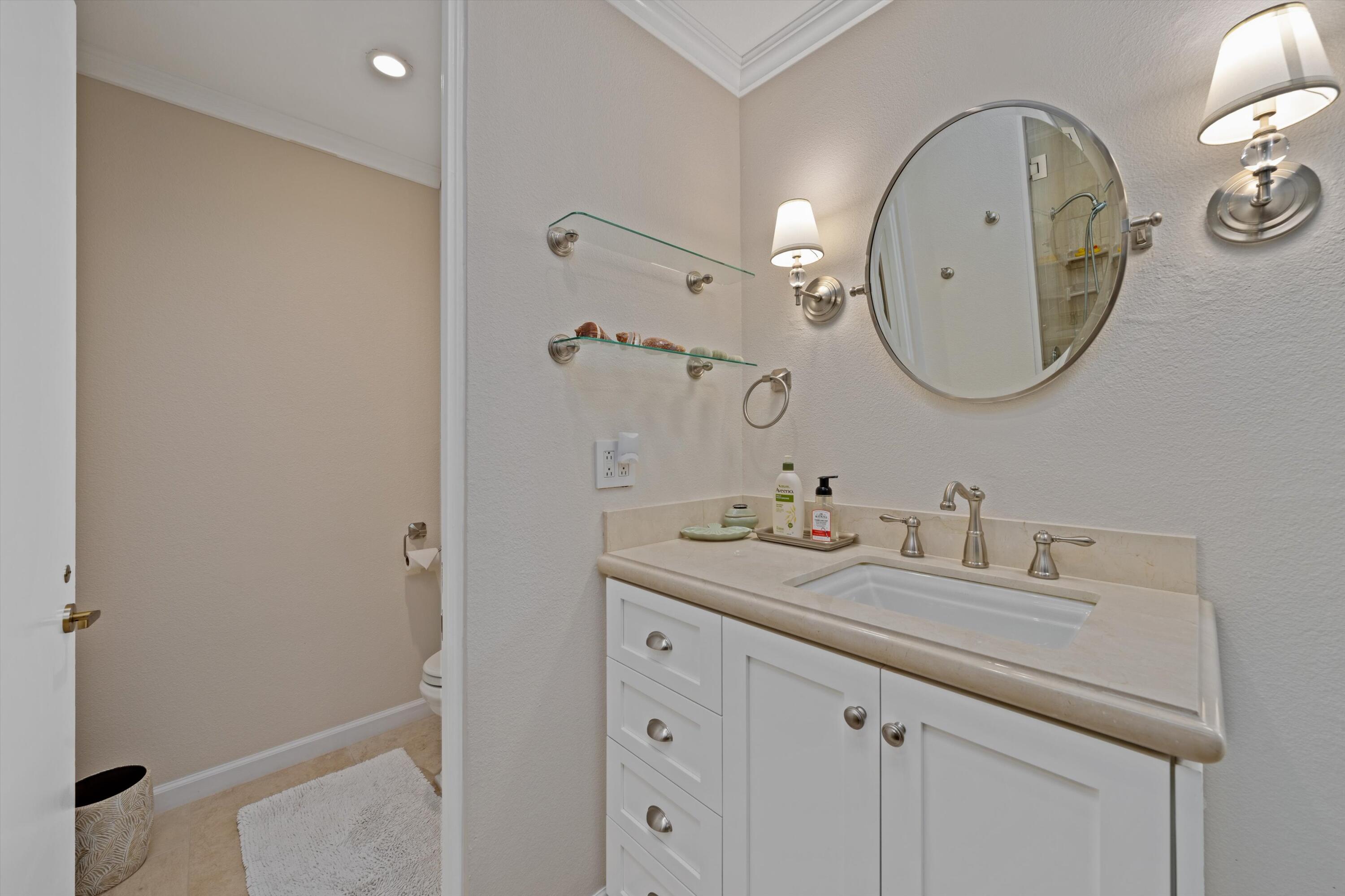 1 Mayfair Drive Rancho Mirage, CA 92270 - Photo 35 of 40 a bathroom with a sink and a mirror
