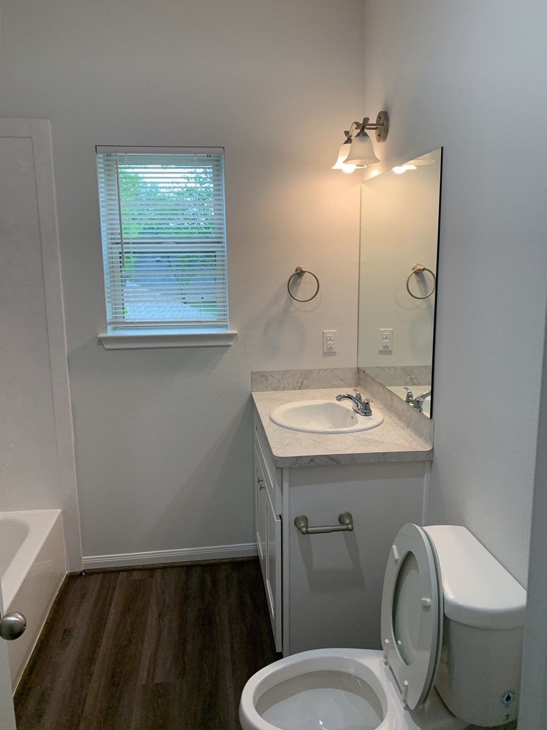 9027 Nyssa Street, Unit A Houston, TX 77078 - Photo 10 of 14 a bathroom with a toilet sink and mirror