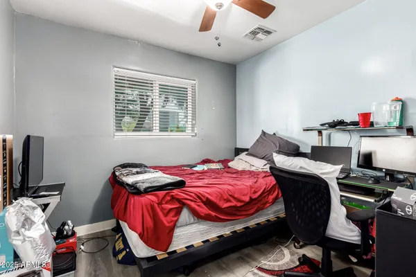 a bedroom with a bed and a chandelier