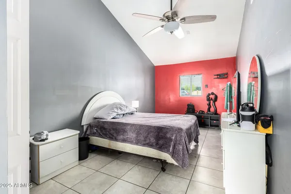 a living room with a bed and a flat screen tv