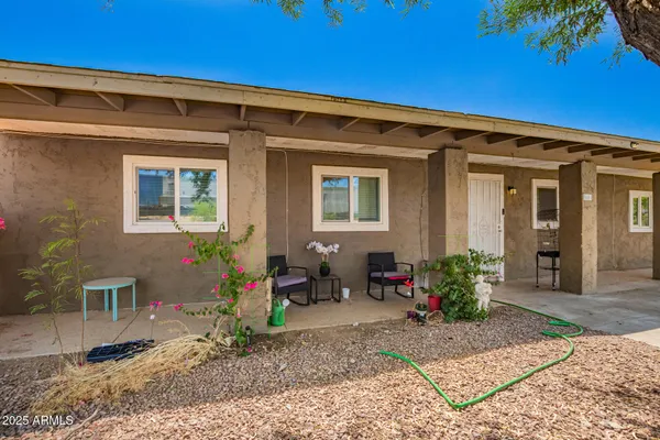 a front view of a house with outdoor seating and plants