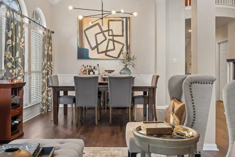 a dining room with furniture and wooden floor