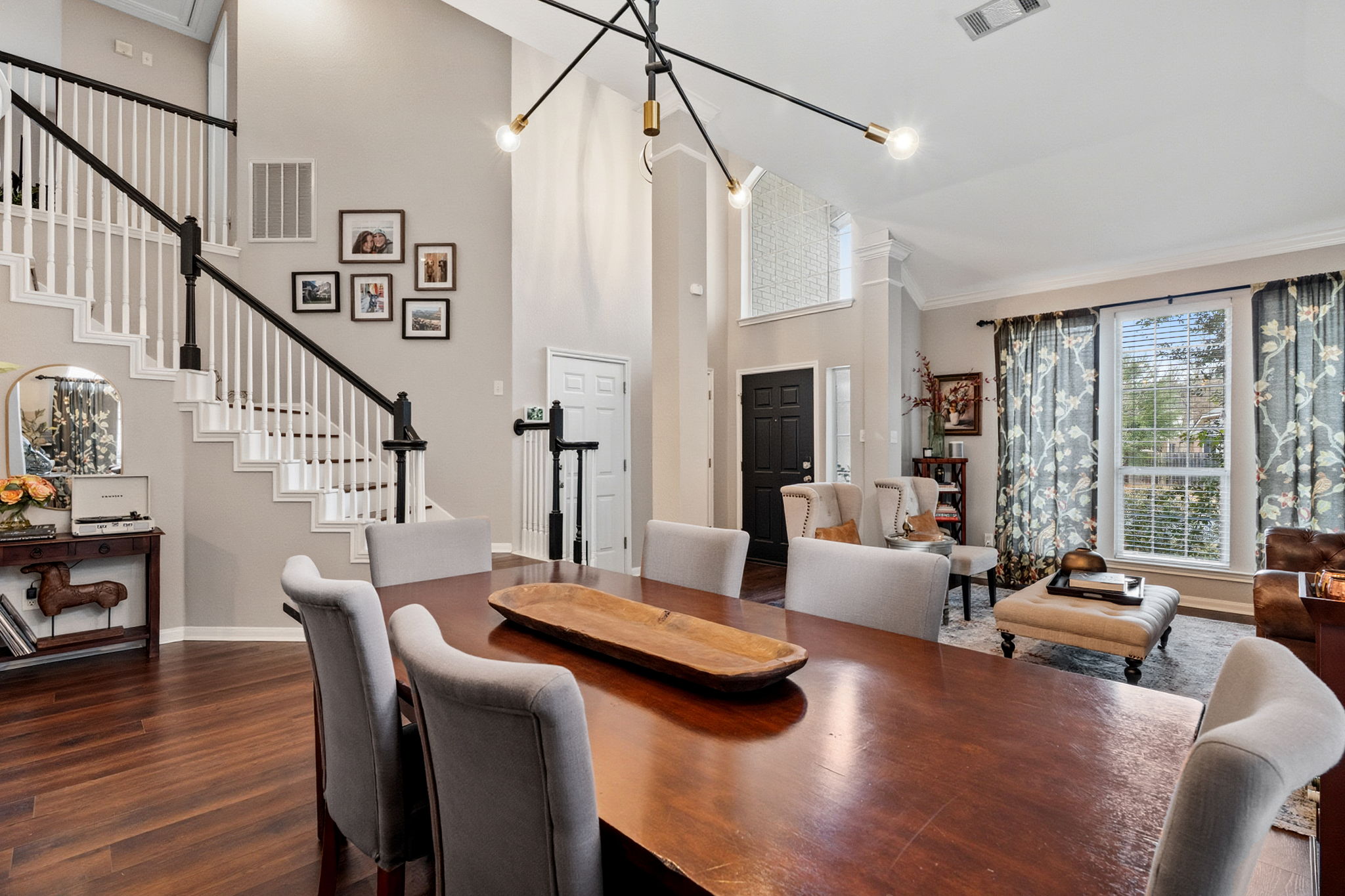 13208 Calf Roping Trail Austin, TX 78727 - Photo 14 of 40 The statement chandelier elevates the formal dining room with modern elegance.