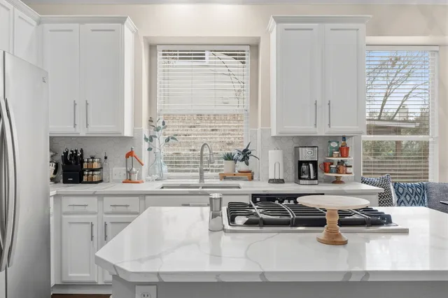 a kitchen with a sink cabinets and window