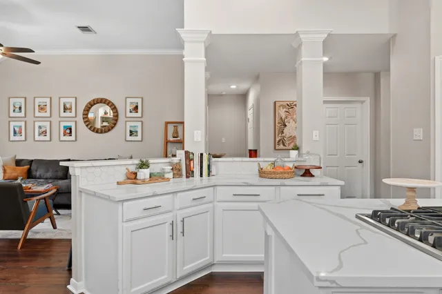 a view of cabinets a sink and a stove in a kitchen