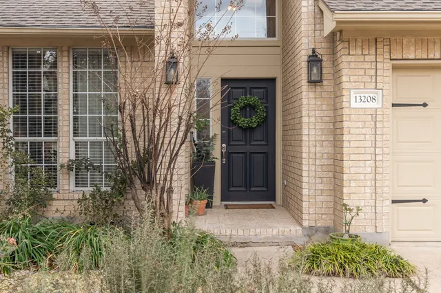 a view of front door and potted plants