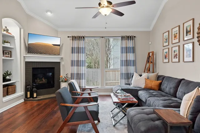 a living room with furniture fireplace and a large window