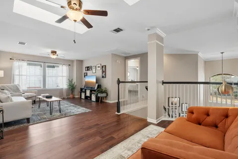 a living room with furniture and wooden floor
