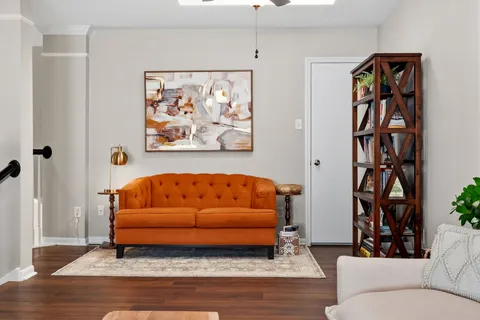 a living room with furniture and a book shelf