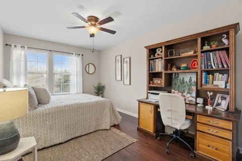 a bedroom with furniture and a book shelf