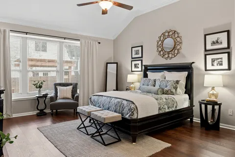 a bedroom with a bed and a chandelier