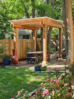 a view of a house with backyard sitting area and garden