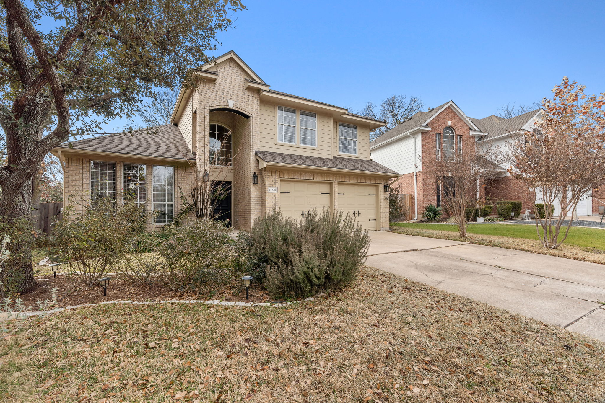 13208 Calf Roping Trail Austin, TX 78727 - Photo 7 of 40 Wide driveway and attached garage provide ample parking.