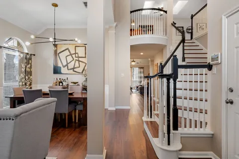 a view of entryway and hall with wooden floor