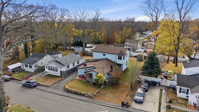 an aerial view of a house with a garden and tree