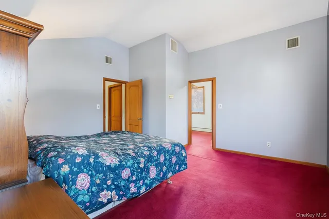 a bedroom with a bed and dresser