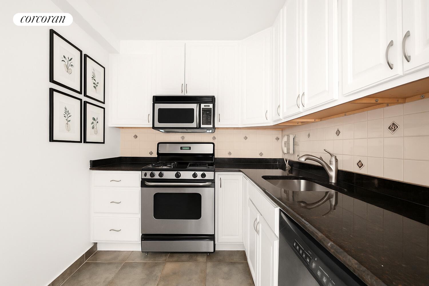 15 West 72nd Street, Unit 9H Manhattan, NY 10023 - Photo 3 of 9 a kitchen with granite countertop a stove sink and microwave