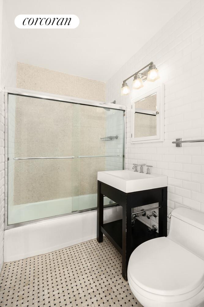 15 West 72nd Street, Unit 9H Manhattan, NY 10023 - Photo 5 of 9 a bathroom with a sink a toilet and shower