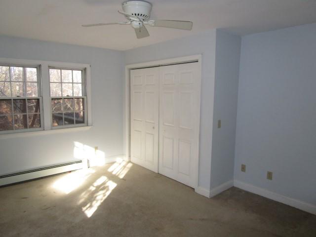 18 Chipman Road Sandwich, MA 02563 - Photo 9 of 16 en empty room with windows and chandelier fan