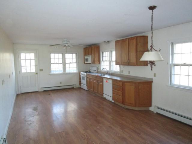 18 Chipman Road Sandwich, MA 02563 - Photo 10 of 16 a kitchen with stainless steel appliances granite countertop a sink a window and wooden floors