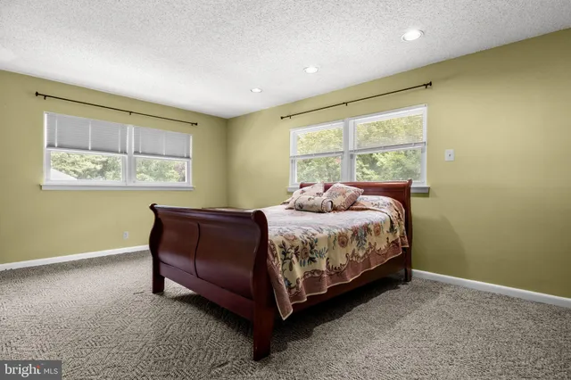 a bedroom with a bed lamp and window