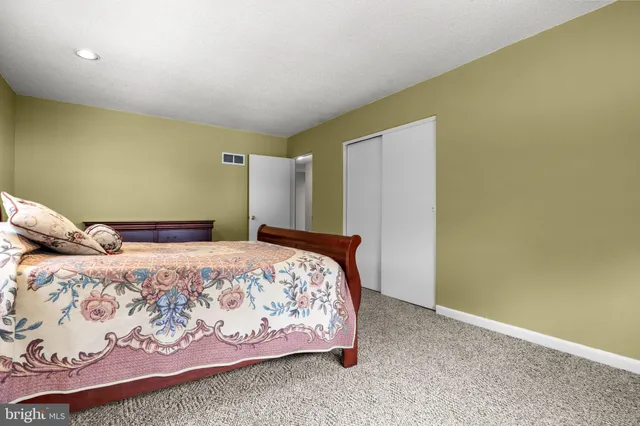 a bedroom with a bed and mirror