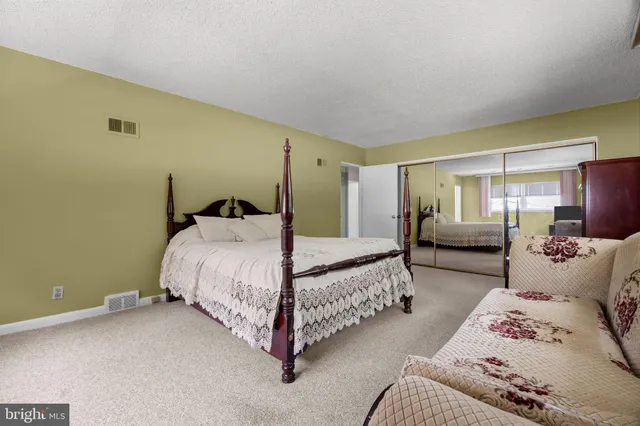 a bedroom with a bed and a couch