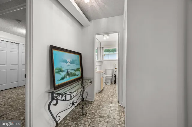 a living room with furniture a flat screen tv and a floor to ceiling window