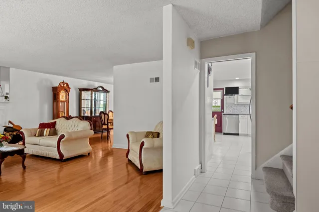 a bedroom with furniture and a wooden floor