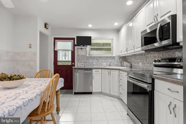 a kitchen with stainless steel appliances granite countertop a sink and microwave