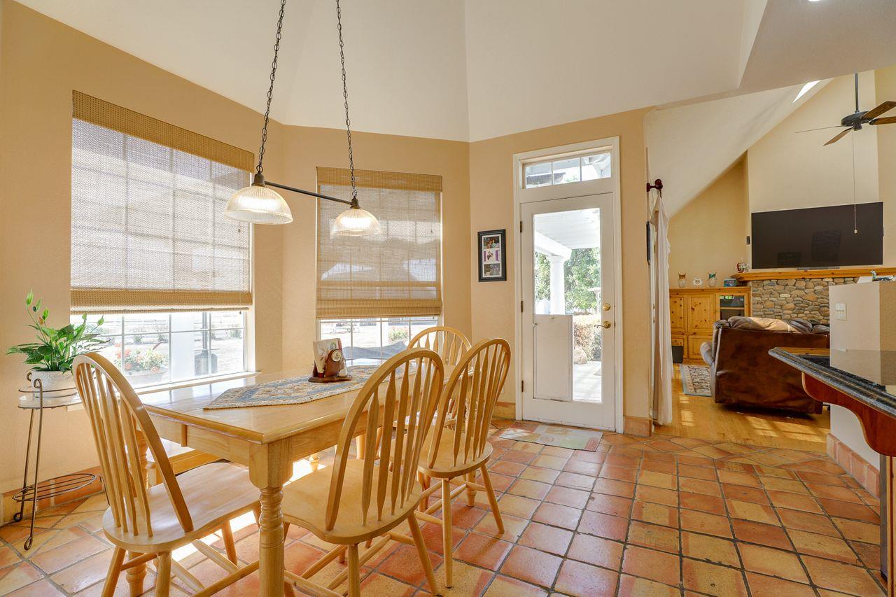 5560 Diablo Hills Road Tres Pinos, CA 95075 - Photo 20 of 46 a view of a dining room with furniture a fireplace and windows