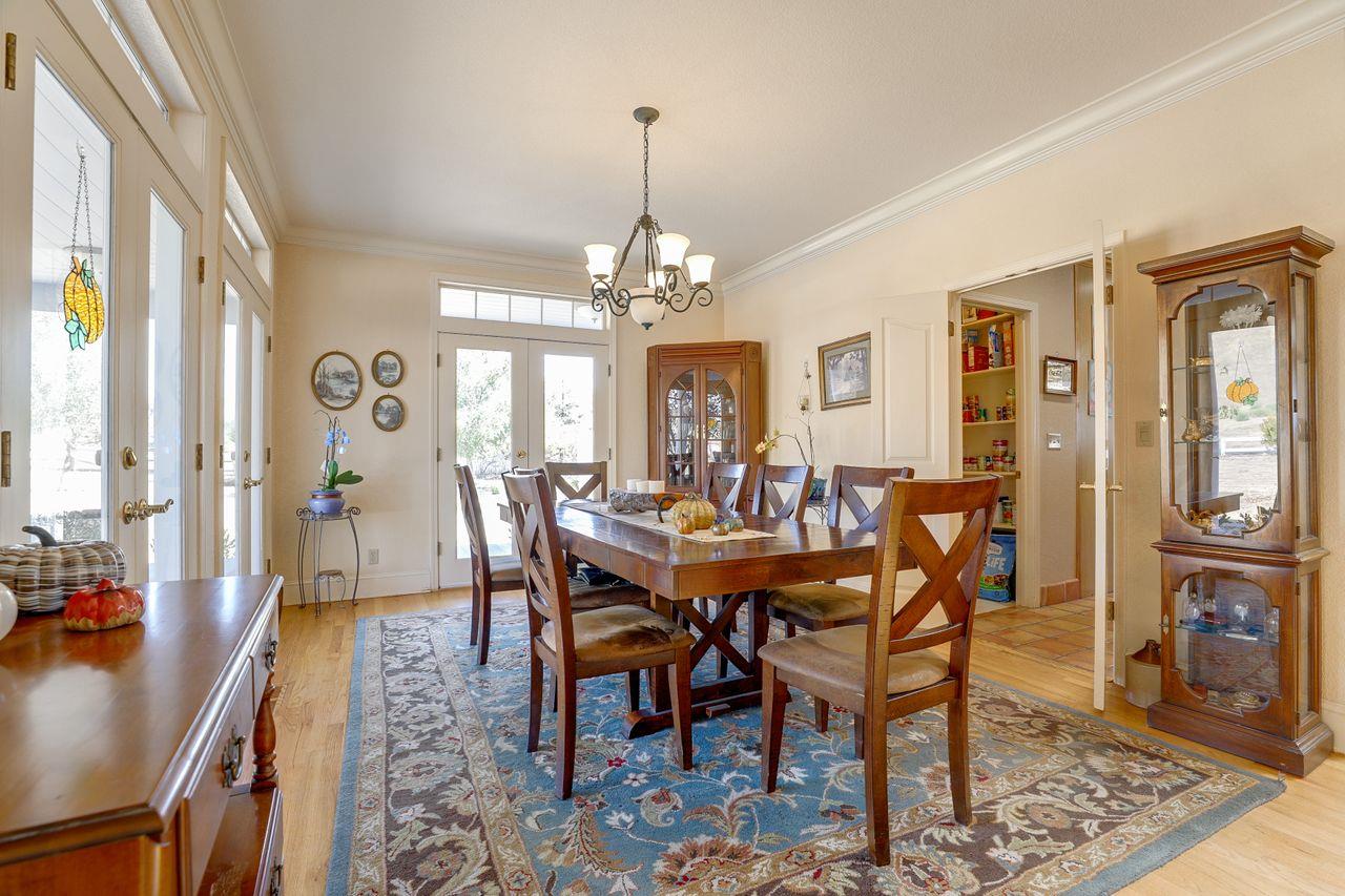5560 Diablo Hills Road Tres Pinos, CA 95075 - Photo 7 of 46 a view of a dining room with furniture and chandelier