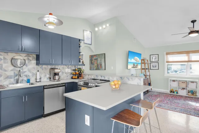 a kitchen with a sink a stove and cabinets