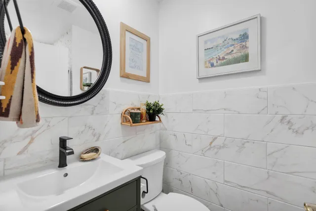 a bathroom with a sink mirror and toilet
