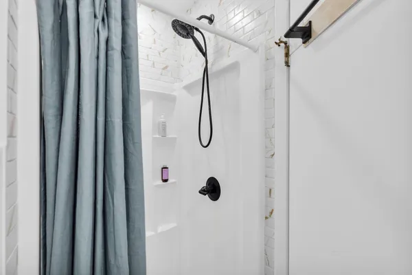 a bathroom with a glass shower door