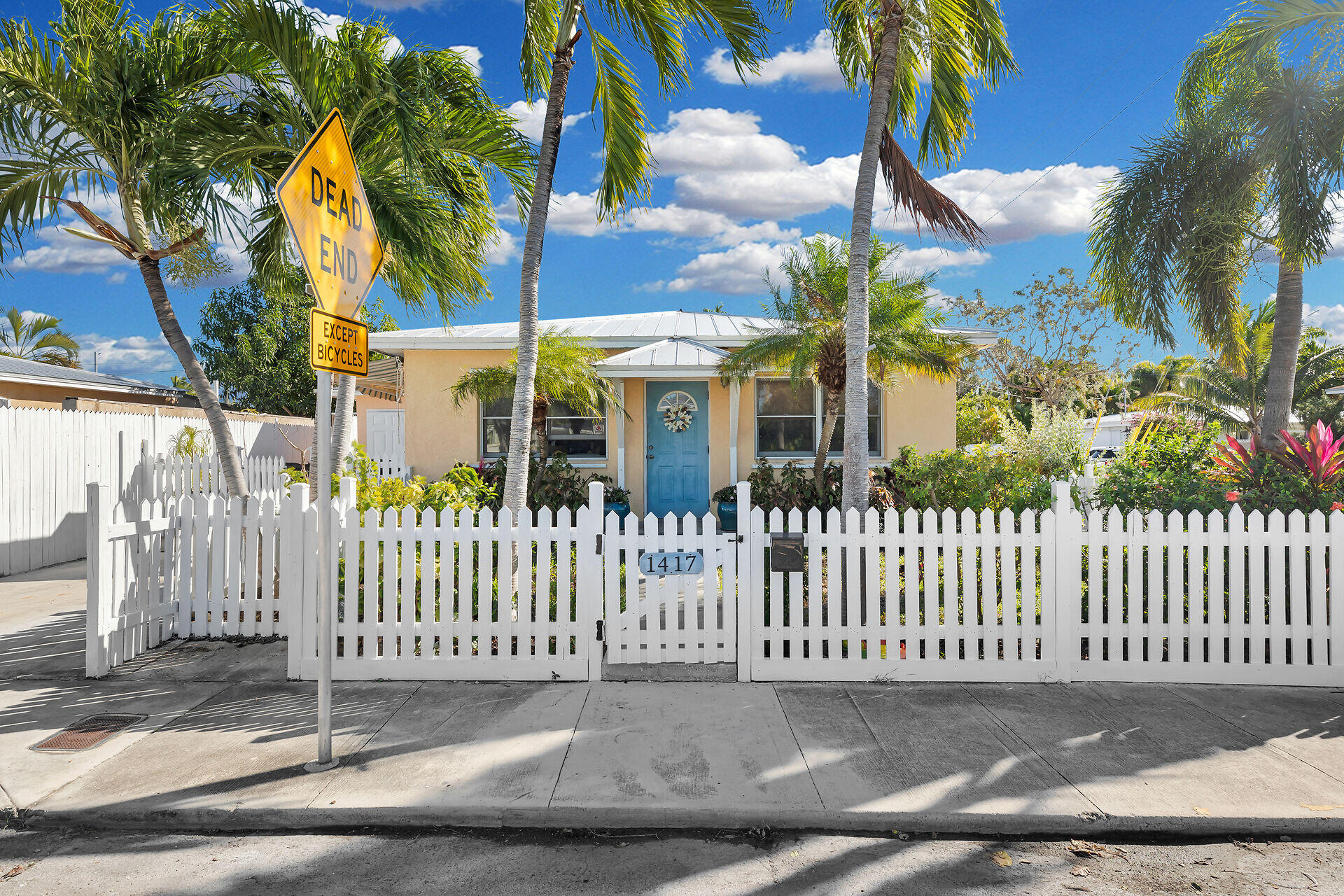 1417 8th Street Key West, FL 33040 - Photo 2 of 44 a view of a white house with a small yard and plants