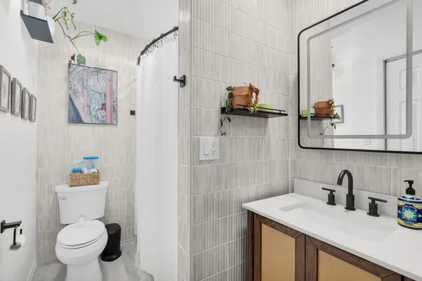 a bathroom with a toilet sink and mirror